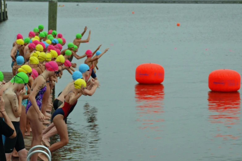 the people are wearing colorful hats and bathing suits