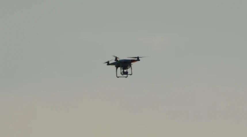 an airplane is flying against a gray sky