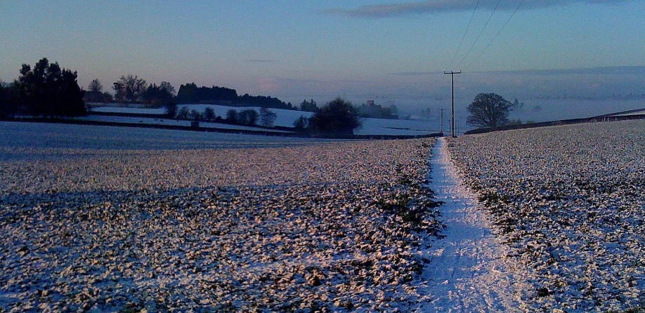 a dirt road that has been cleared to a clear and beautiful sunset