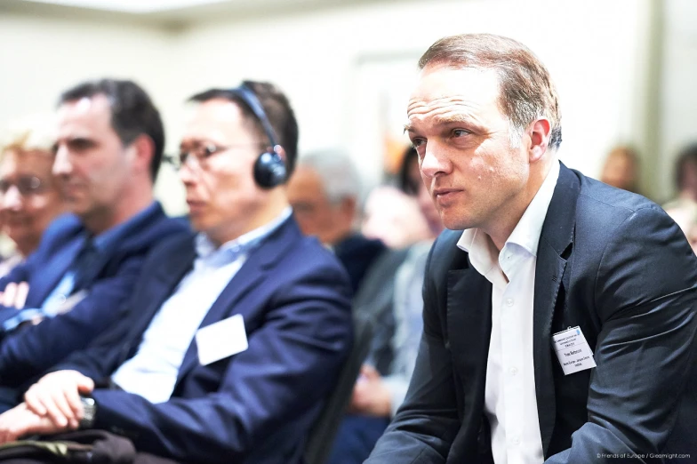 the audience looks on at a presentation for business people