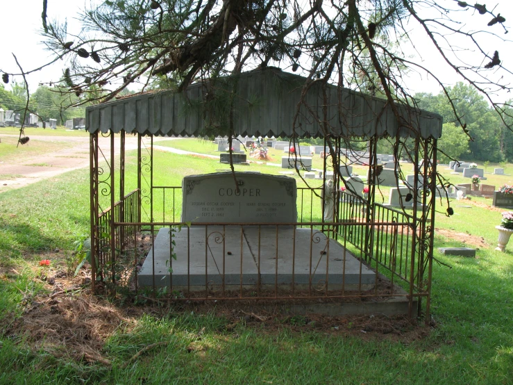 a cemetery area, with an old wrought iron cremat and gravestones