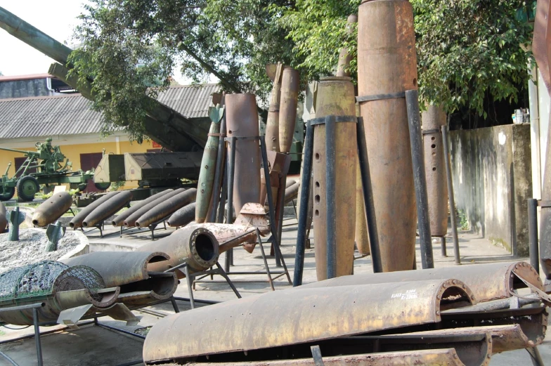 an assortment of steel objects next to a tree