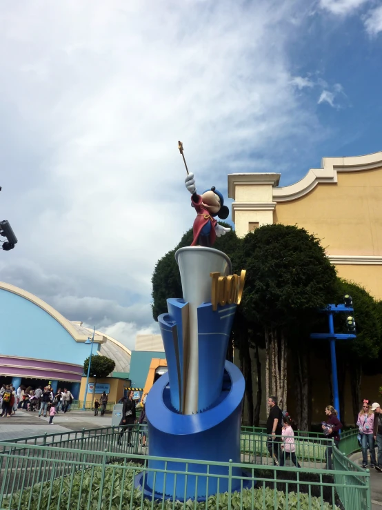 a statue of a man on a giant blue object