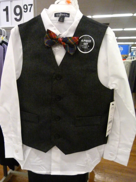a suit vest and bow tie displayed on a rack