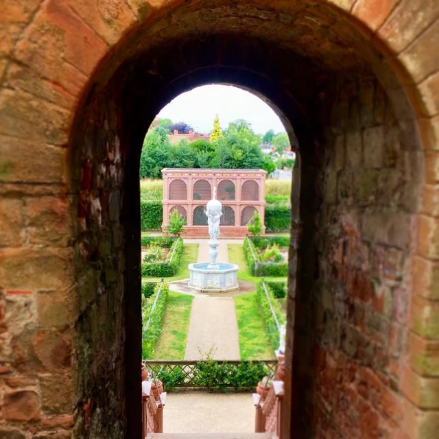 a doorway opens into the garden that looks like an old castle