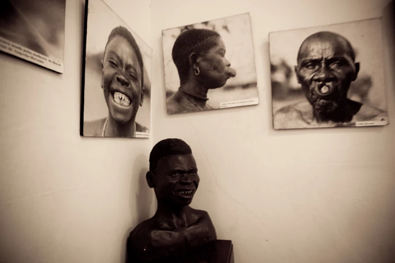 three framed pictures on the wall of an african american man