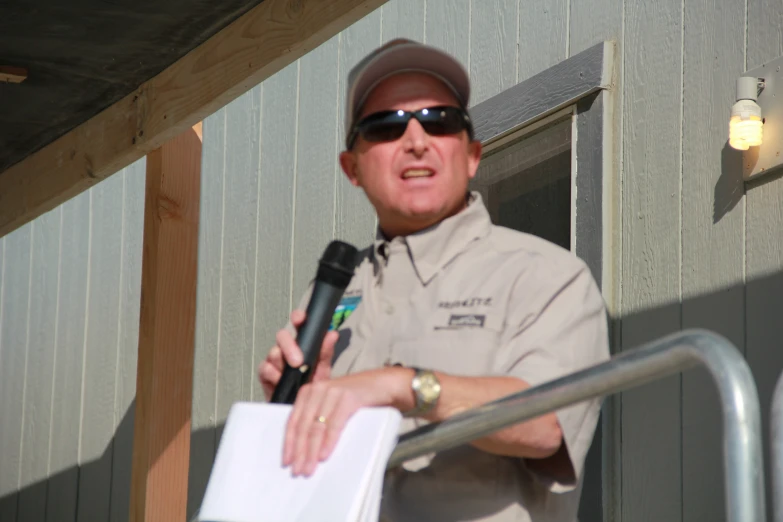 a man talking to an officer who is holding a microphone