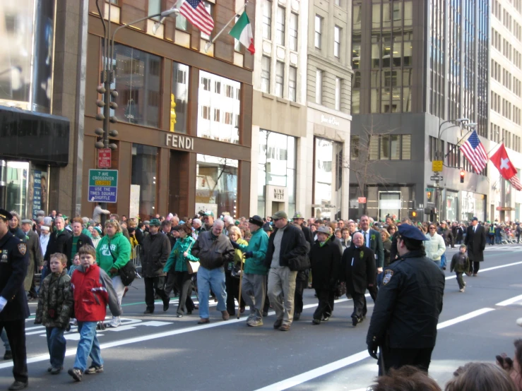 a large group of people are walking in a street