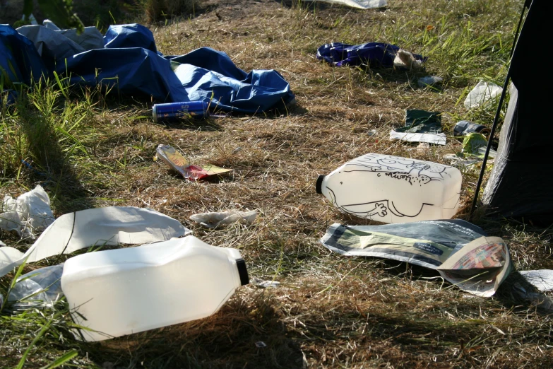 discarded and broken white plates, a baseball cap and others
