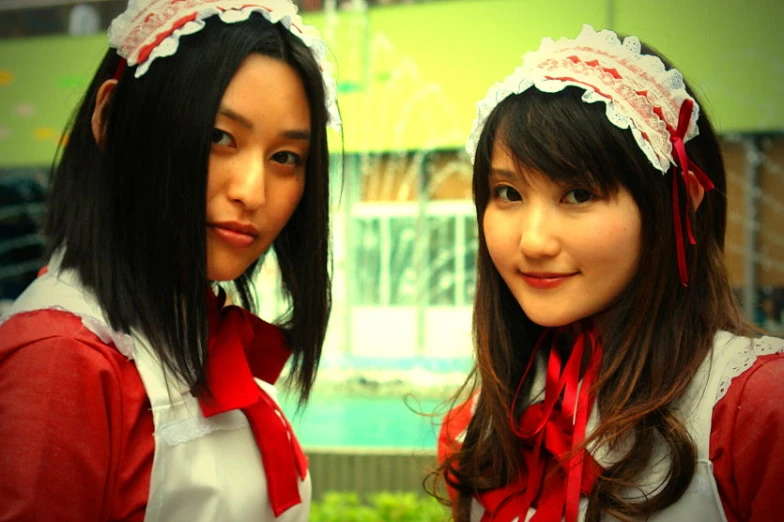 two girls dressed as a schoolgirl pose for a picture