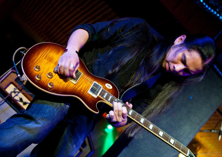 a close up of a person playing an electric guitar