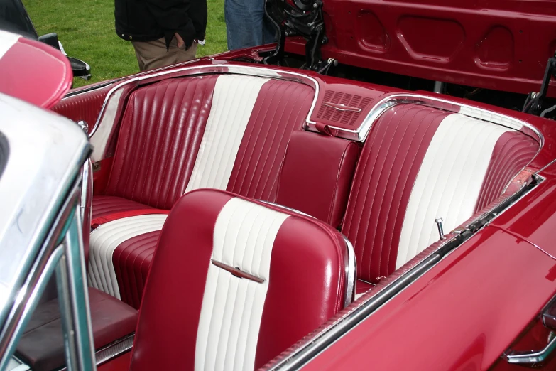 vintage cars sit next to each other in their convertibles