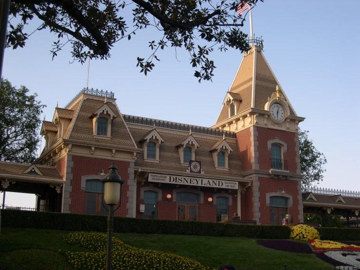 the building has an unusual steeple and a clock at the top of the tower