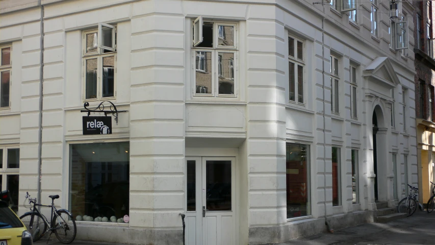 a white building with some bicycles parked outside of it