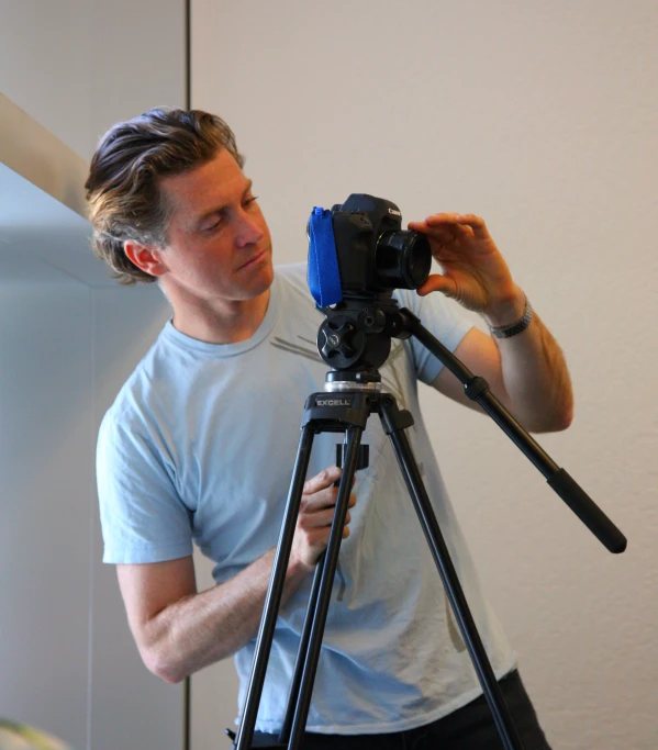 a man using a tripod for taking pictures