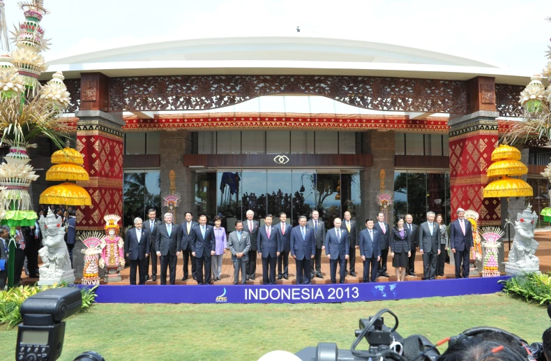 a large group of people posing in front of a building