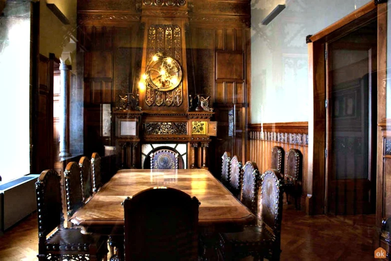 there is a dining table in the room with an ornate clock on it