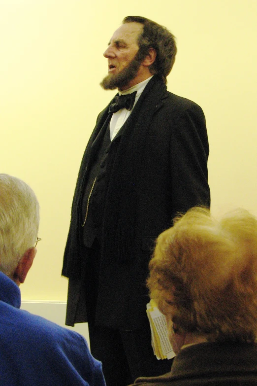 a man standing in front of people with an audience