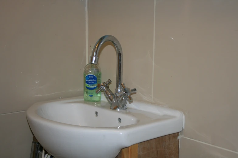 there is a small bottle of deodorant next to a sink