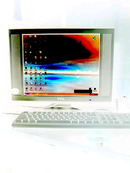 a computer monitor with a keyboard on a table