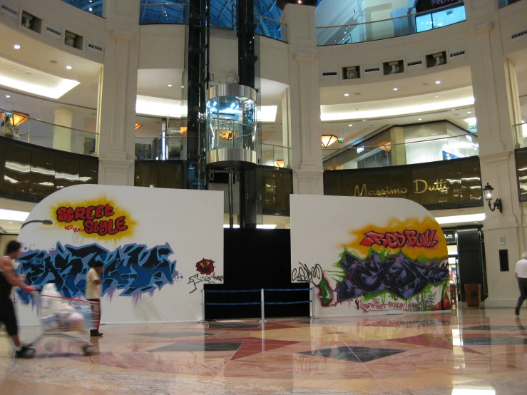 the inside of a building has several signs with graffiti
