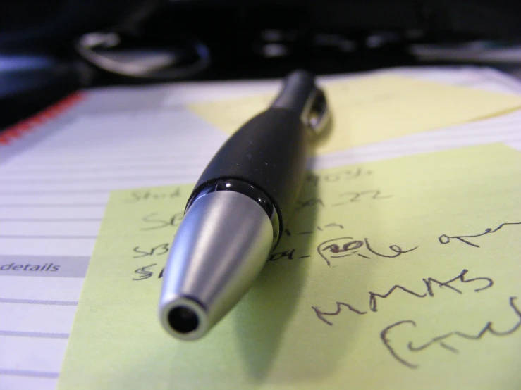 a pen sitting on a paper with writing and notes
