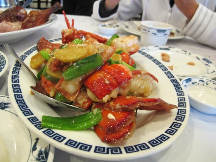 a plate of food on a table with plates and silverware