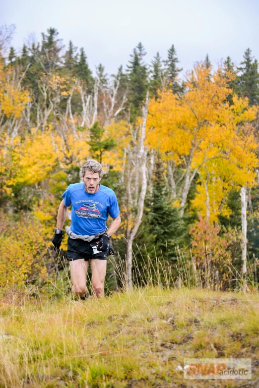 there is a man running on a trail