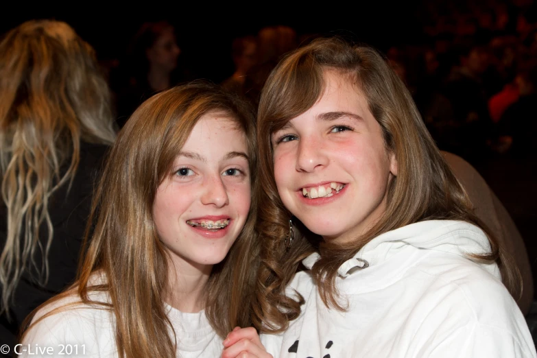 two girls posing for a po together at a party