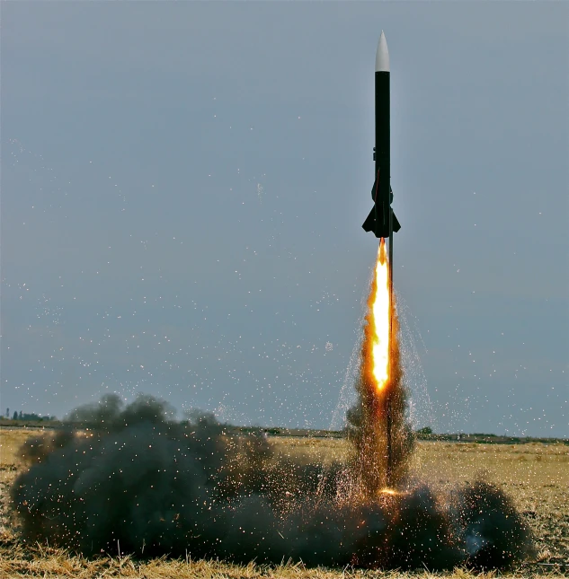 an airplane carrying a rocket flying through the sky