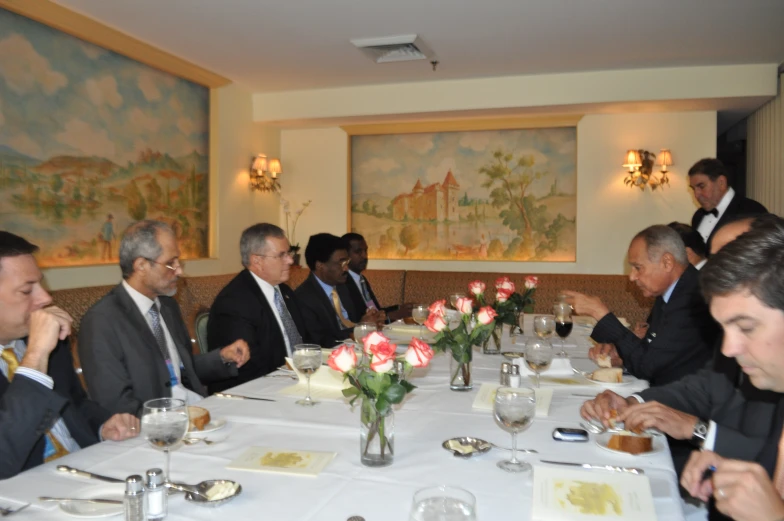 several people at a table looking at pographs on the walls