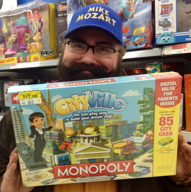 a man holding up a monopoly box while in front of a store shelf