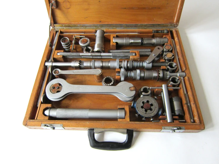 an open wooden box filled with different tools