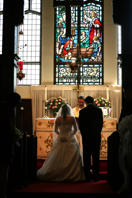 a bride and groom standing at the end of the aisle of their wedding ceremony