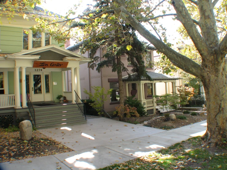 a small home with an elegant porch and landscaping