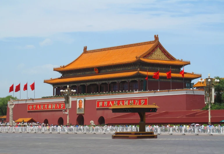 a red building with many flags surrounding it