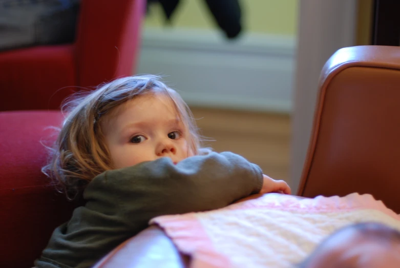 a little girl that is sitting down on a chair