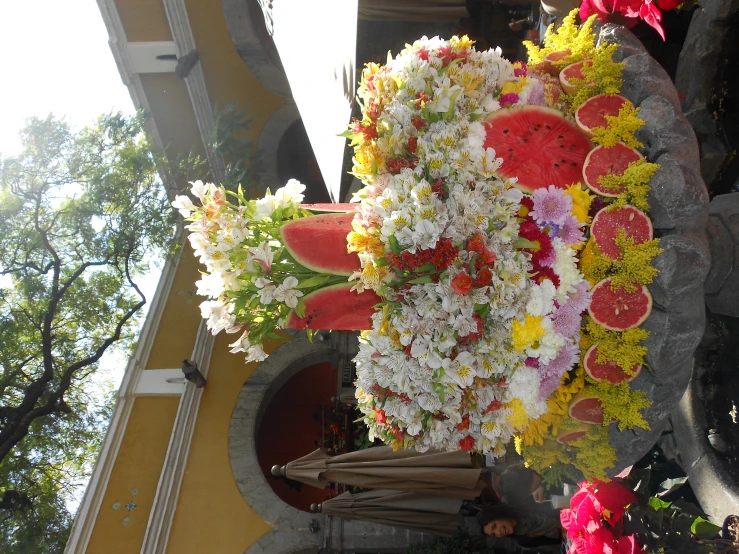 a vase filled with flowers, gs and fruits