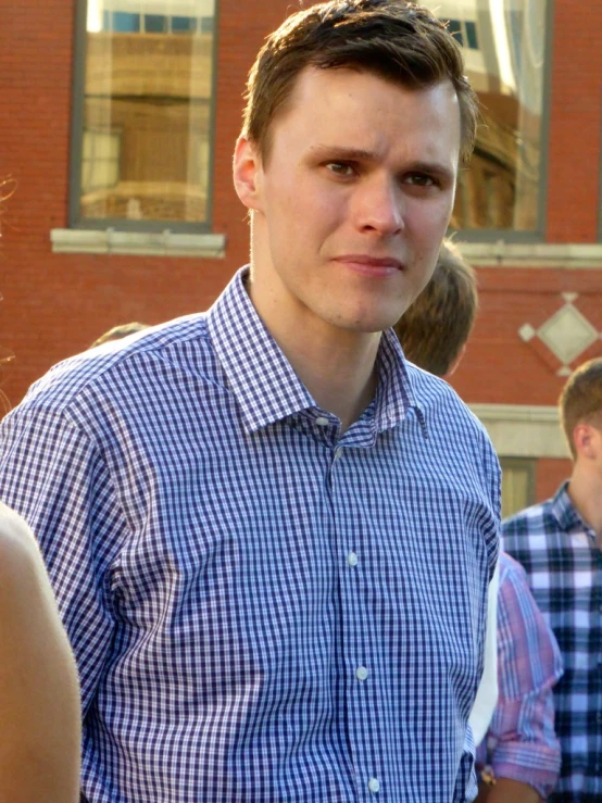 a young man stands in front of a group