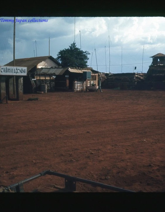 the people walk near their shack in the dirt