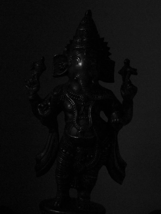 the statue of an indian god is holding two birds