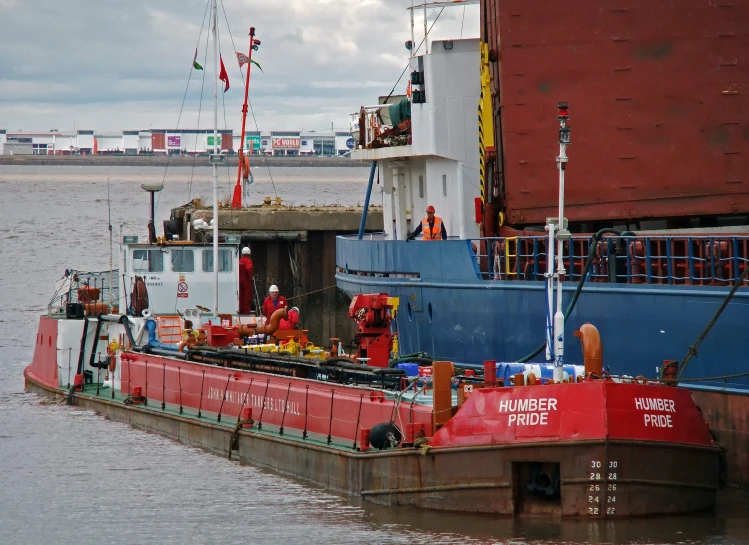 a tug boat on the water by a dock