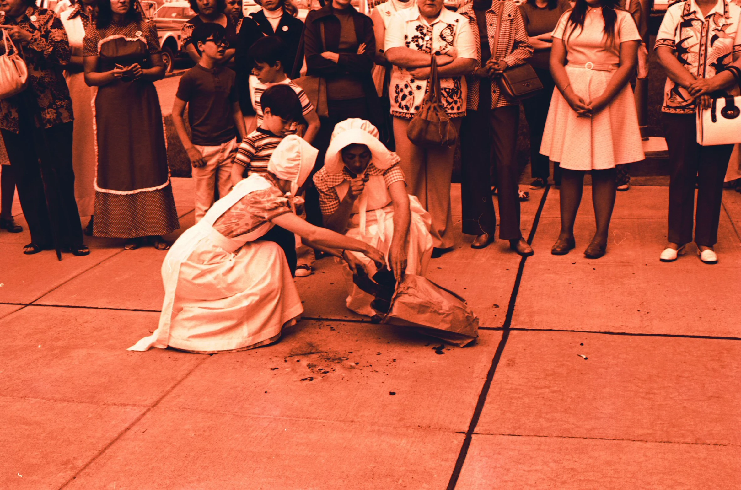 a lady is bending over to pick up soing off the ground