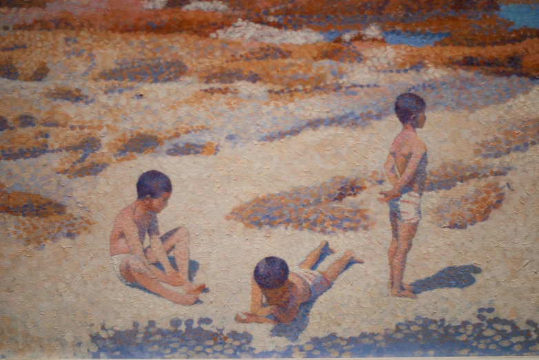 three boys playing in the sand on a beach