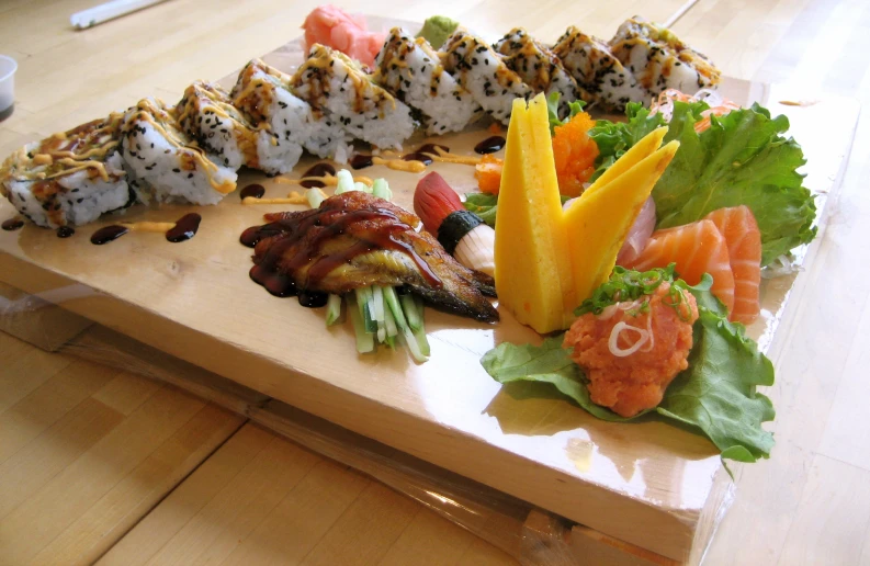 an assortment of sushi and various vegetables on a plate