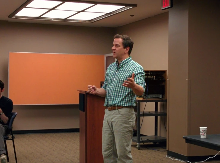 a man giving a presentation at the meeting room