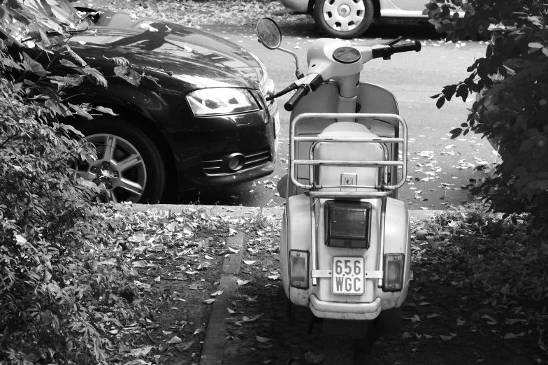 there is an old scooter parked on the street