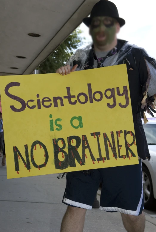 a man in costume is holding a sign