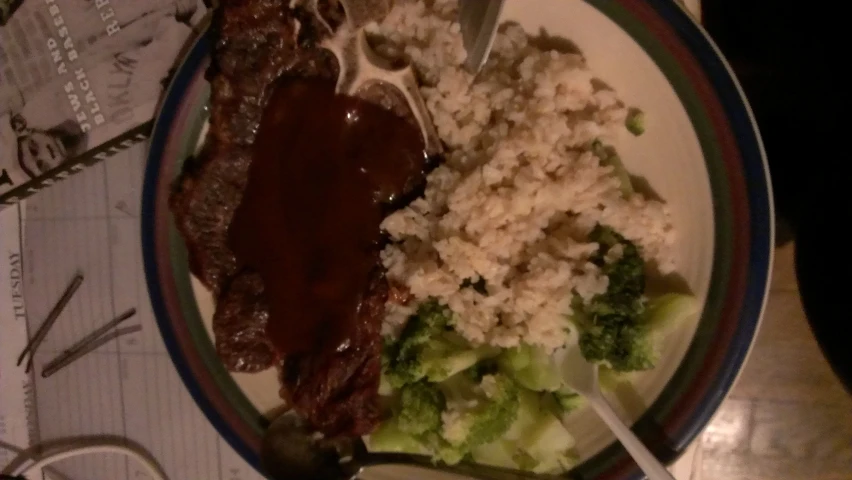 the plate has rice and meat on it