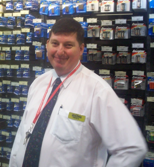 a man with a tie standing in a store